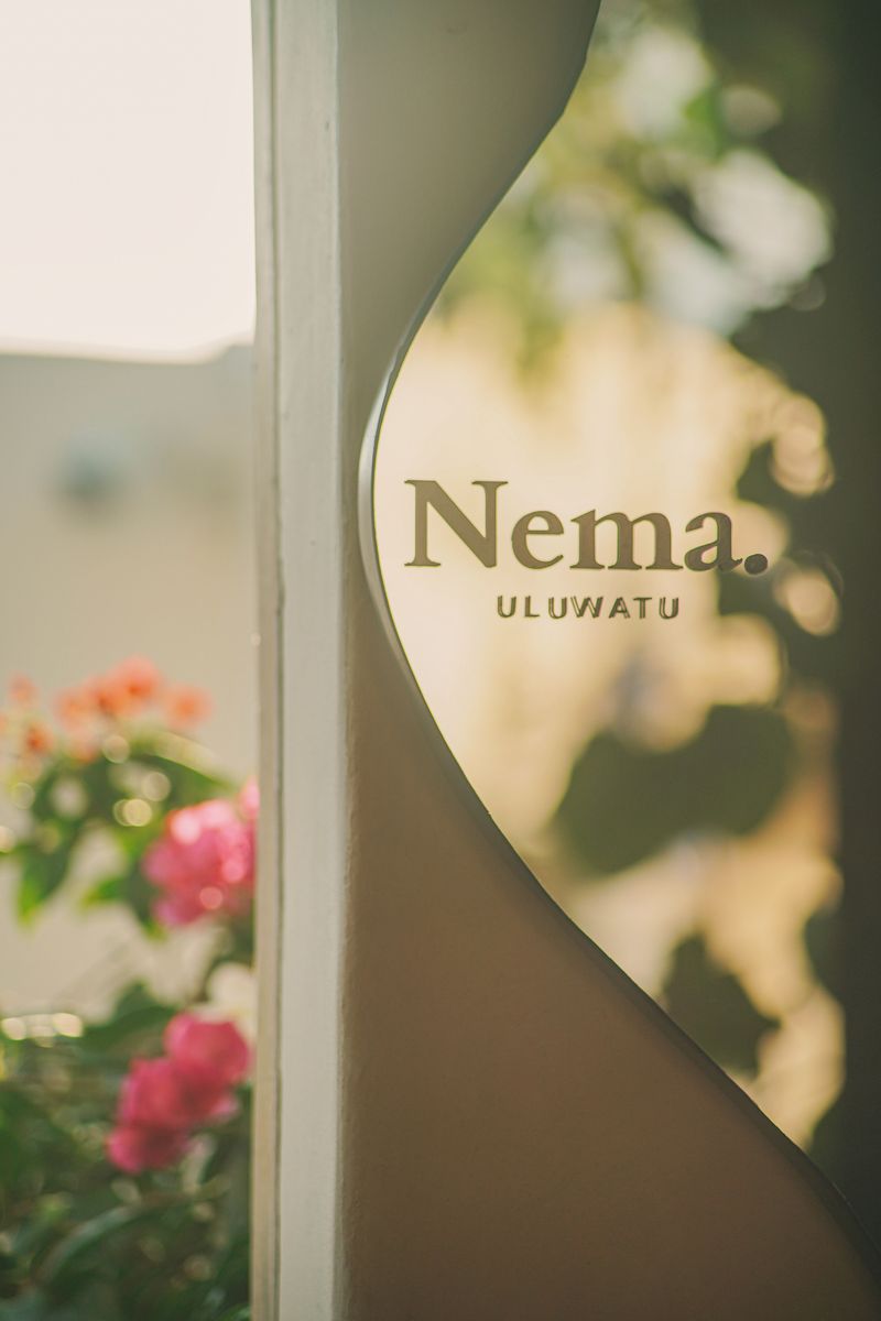 The Nema. sign in a curved, sunlit wall